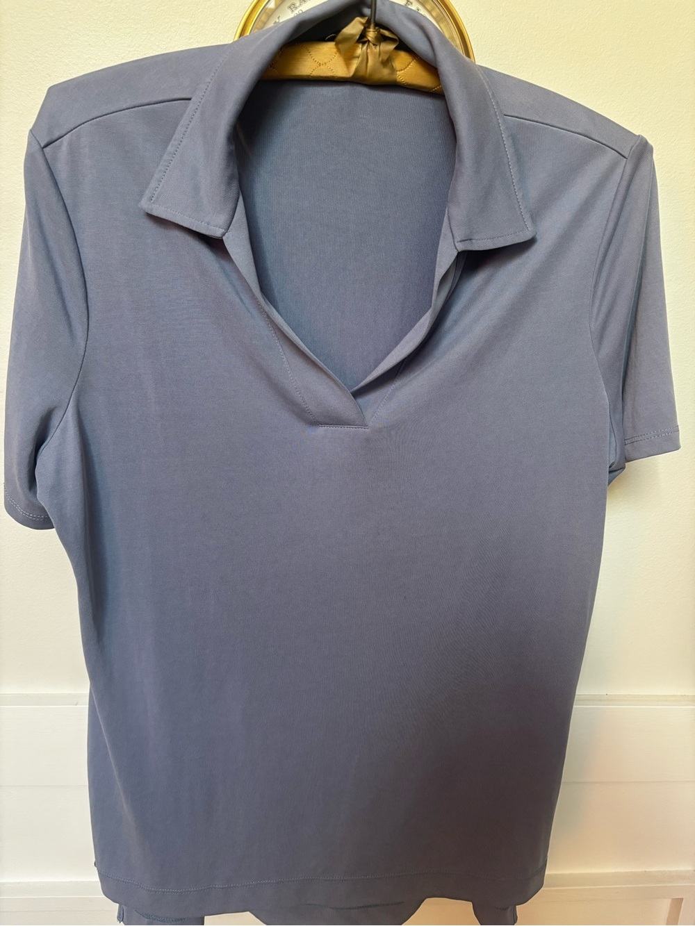 light blue buttonless V-neck polo shirt from the Lisette L Montreal collection.